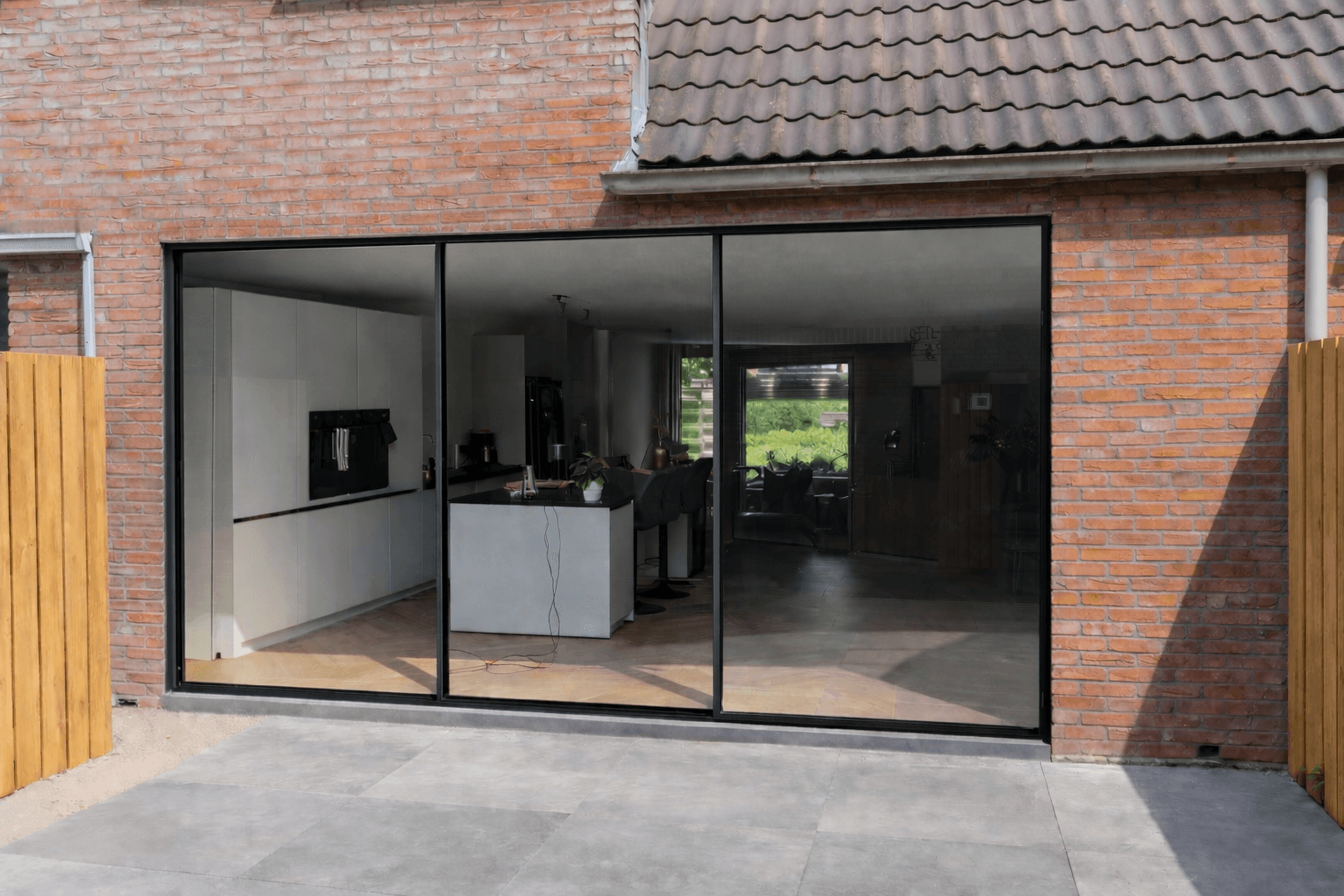 Aluminium schuifpui 3-delig zwart in moderne keuken uitbouw